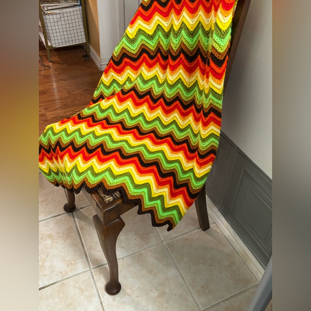 70s hand-crocheted afghan blanket with a colorful chevron (zig-zag) pattern.
